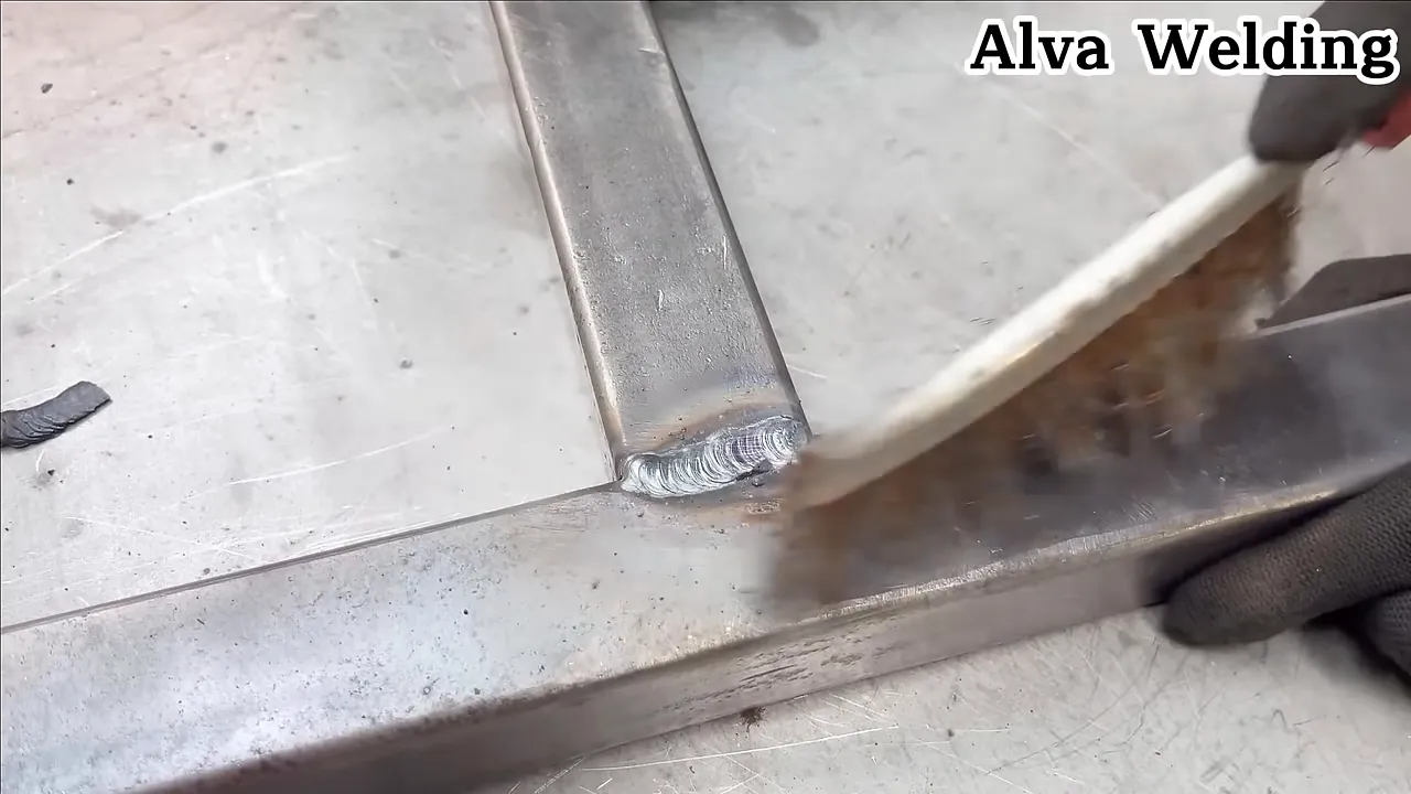 Using a wire brush to remove surface rust before welding