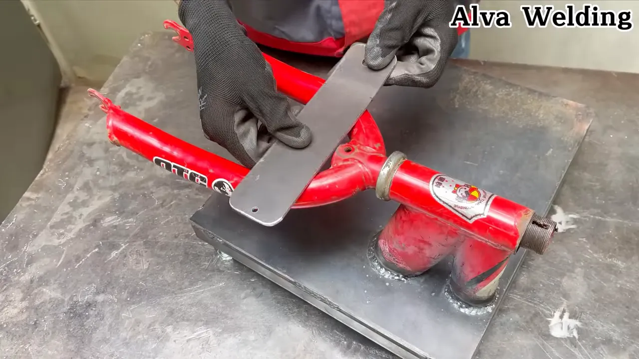 Metal mounting plates cut and drilled, ready to be welded to the bike frame