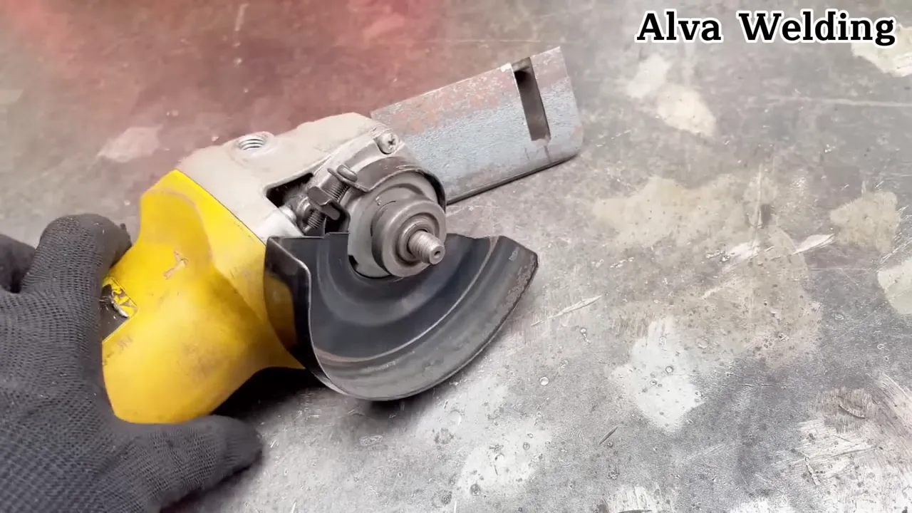angle grinder with a straight edge guide clamped to a metal plate