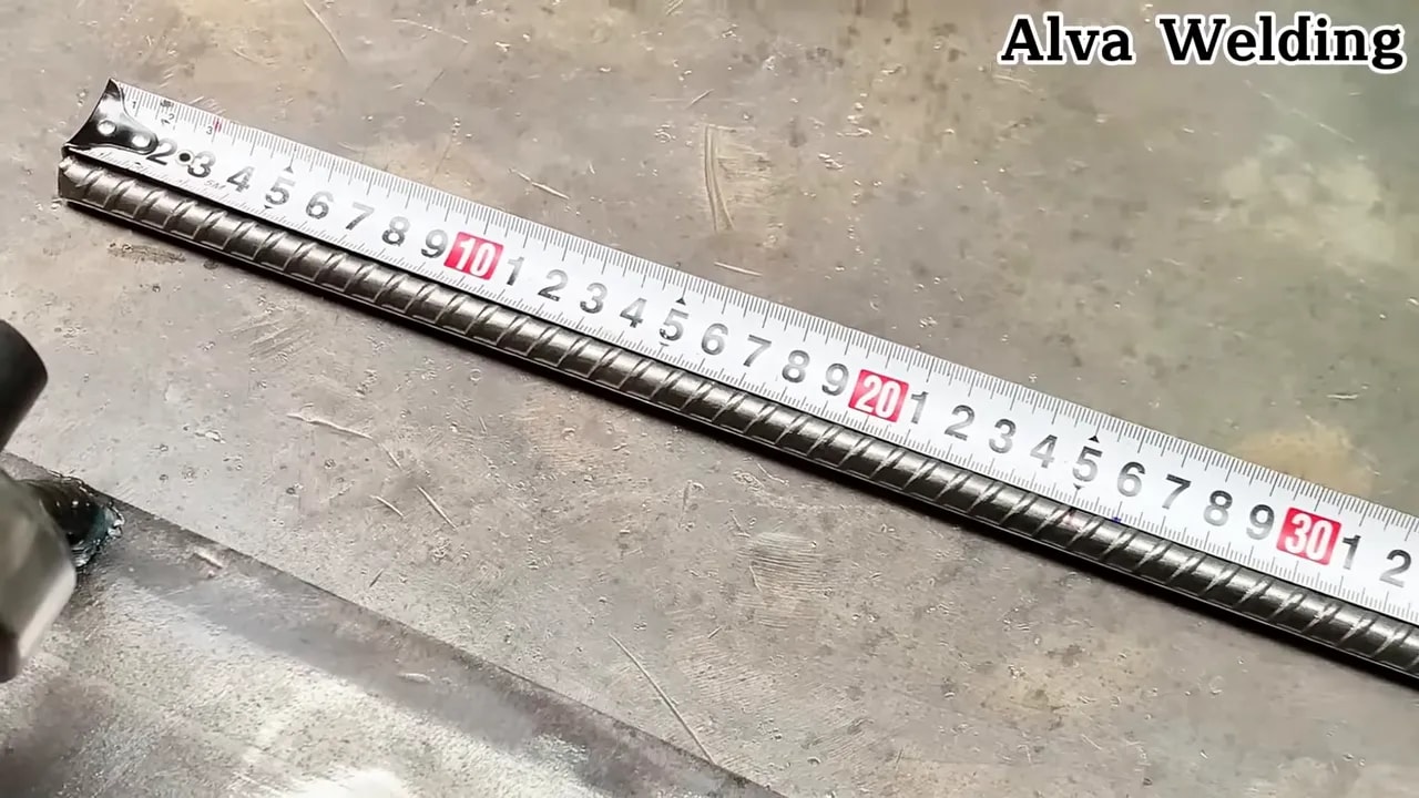Using a steel ruler to measure a metal workpiece
