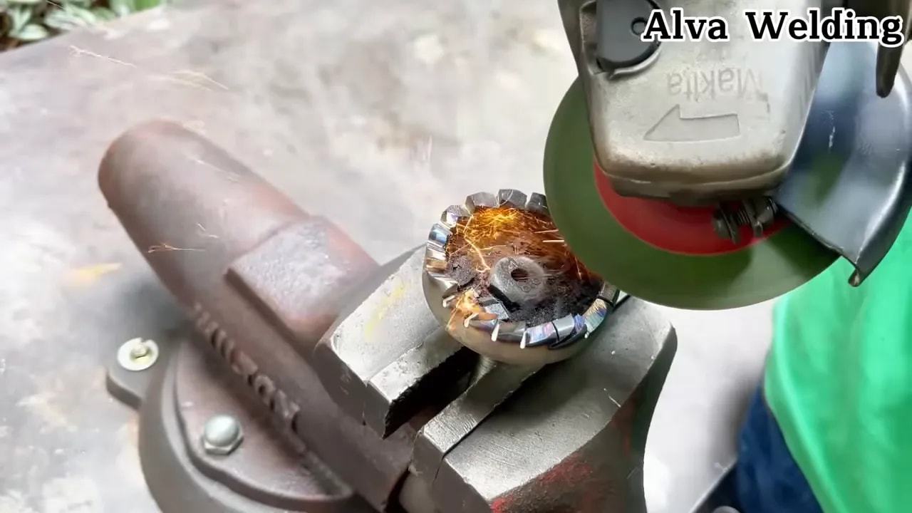 Motorcycle brake disc clamped on a metal base before welding