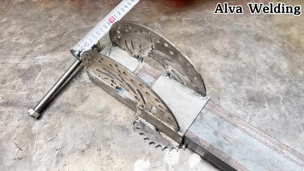 Motorcycle brake disc vise jig with measuring ruler checking alignment before final welding